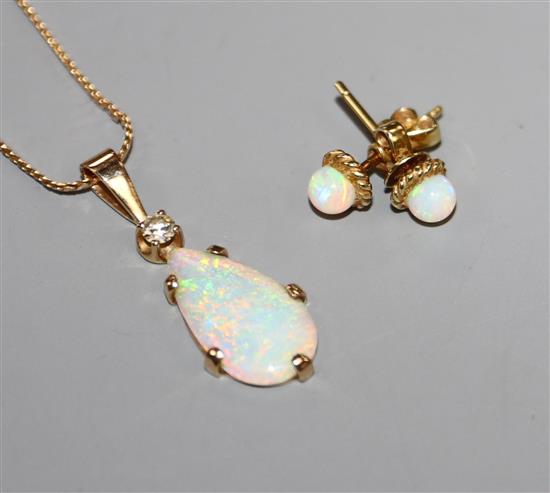 A yellow metal, white opal and diamond set pendant, on a 9ct chain and a pair of 585 and white opal ear studs.